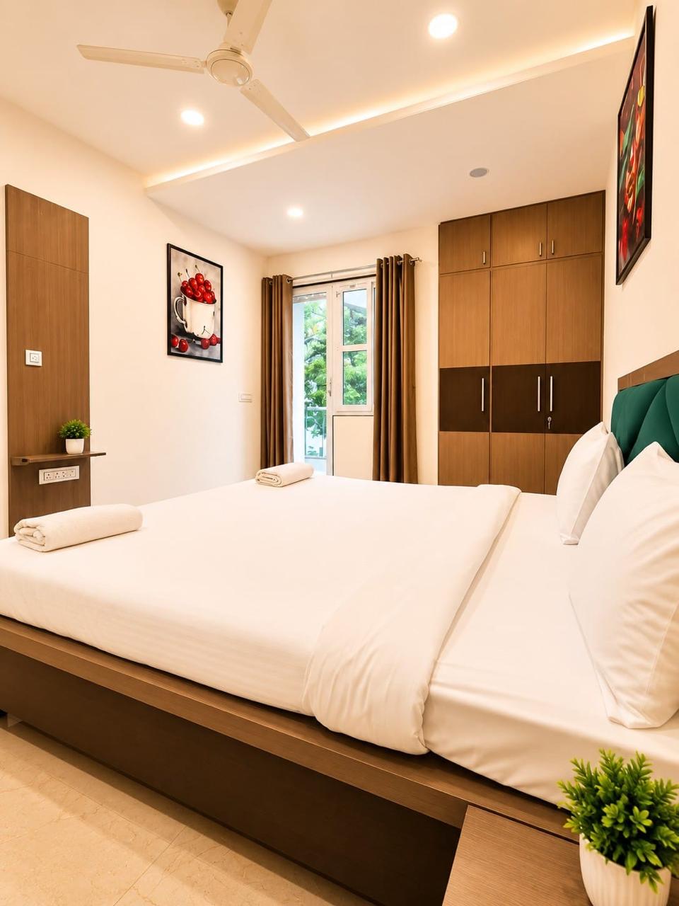 Clean modern apartment interior in Jaipur, neutral tones, well-appointed bedroom with warm lighting, effortless and convenient setting
